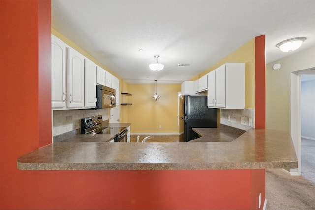 kitchen featuring a peninsula, baseboards, white cabinets, backsplash, and black appliances