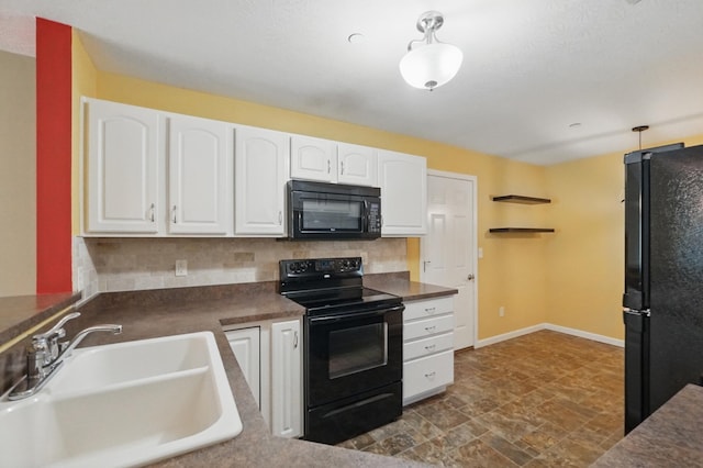kitchen featuring dark countertops, white cabinetry, tasteful backsplash, a sink, and black appliances