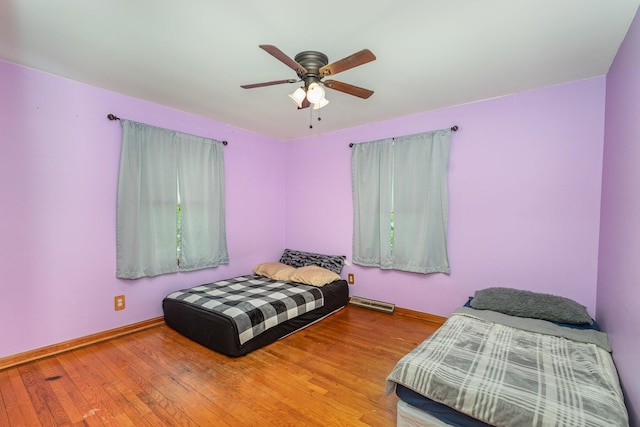 bedroom featuring baseboards, ceiling fan, and wood finished floors