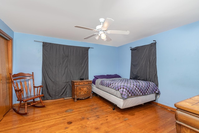 bedroom featuring a ceiling fan and wood finished floors