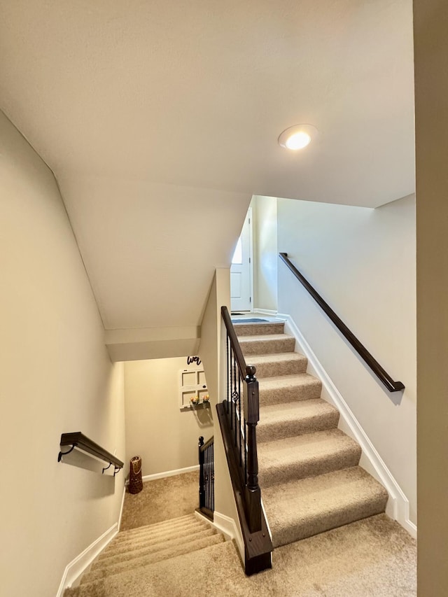 stairway with carpet flooring and baseboards