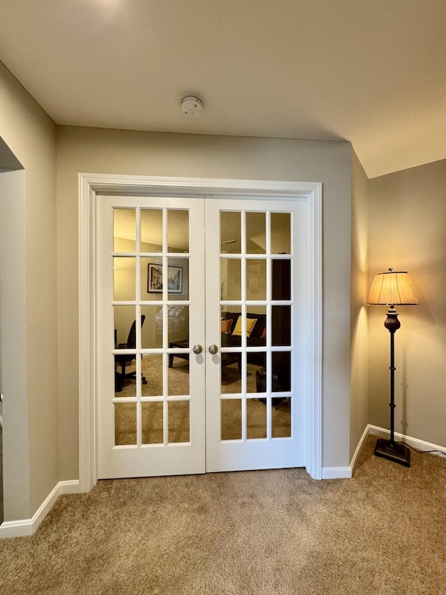 doorway featuring carpet flooring, baseboards, and french doors
