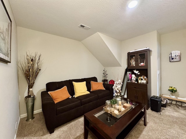 carpeted living room featuring visible vents and baseboards