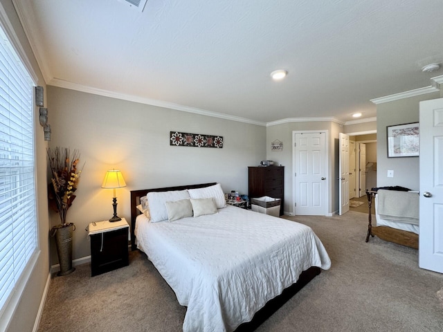 carpeted bedroom featuring baseboards, crown molding, and a closet