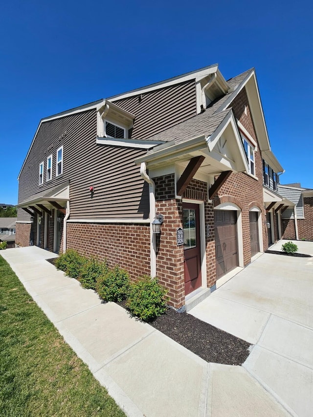 7618 Woodhaven Ct, Alexandria, KY 41001 - view of side of property with brick siding, an attached garage, driveway, and a shingled roof