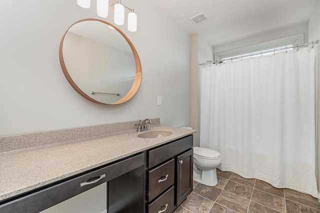 bathroom with toilet, curtained shower, visible vents, and vanity