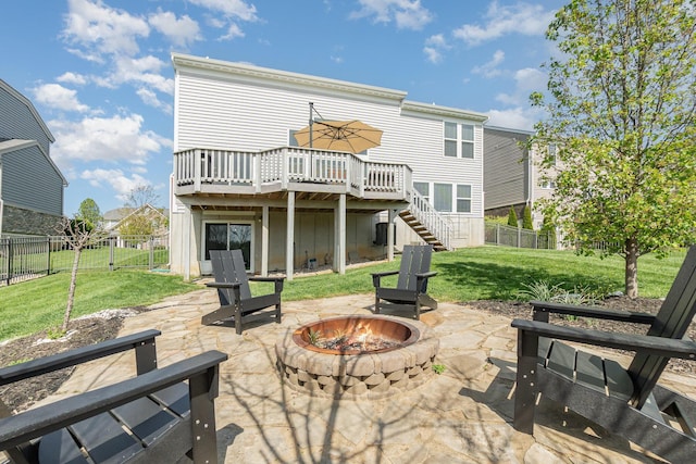 rear view of house with a patio, an outdoor fire pit, a wooden deck, and stairway