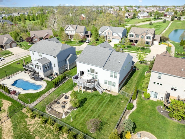 birds eye view of property with a water view and a residential view
