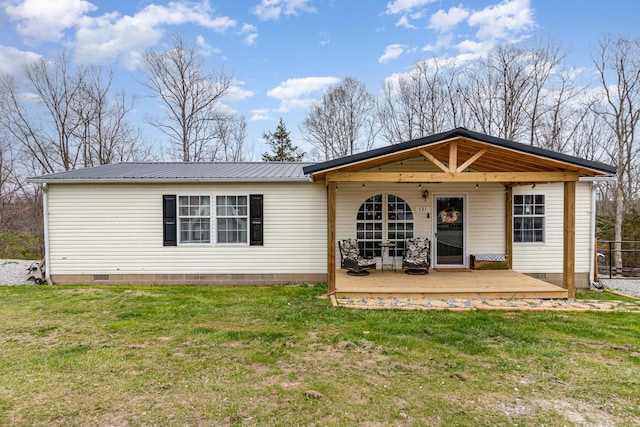 back of house featuring a wooden deck, a yard, crawl space, and metal roof