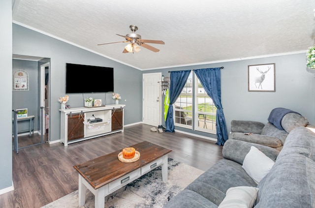living area featuring crown molding, lofted ceiling, wood finished floors, and ceiling fan