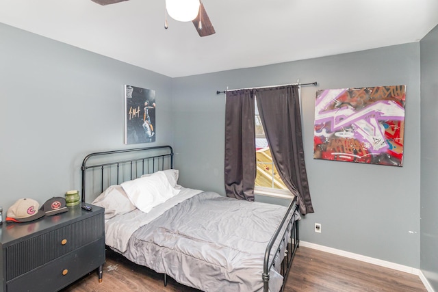 bedroom with baseboards, a ceiling fan, and wood finished floors