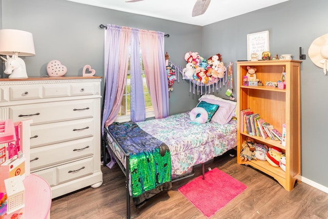 bedroom featuring baseboards, a ceiling fan, and wood finished floors