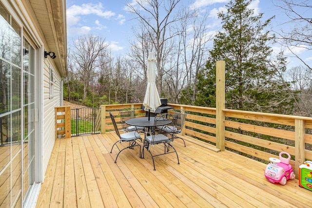 wooden terrace featuring outdoor dining space