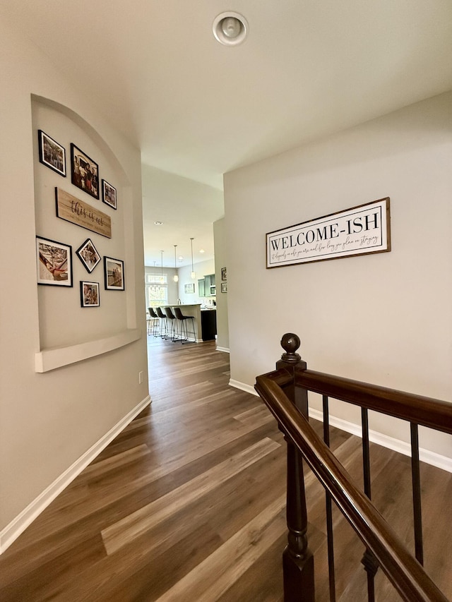hall with baseboards, recessed lighting, and dark wood-type flooring