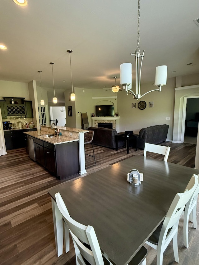 dining room featuring visible vents, dark wood-style floors, and a fireplace