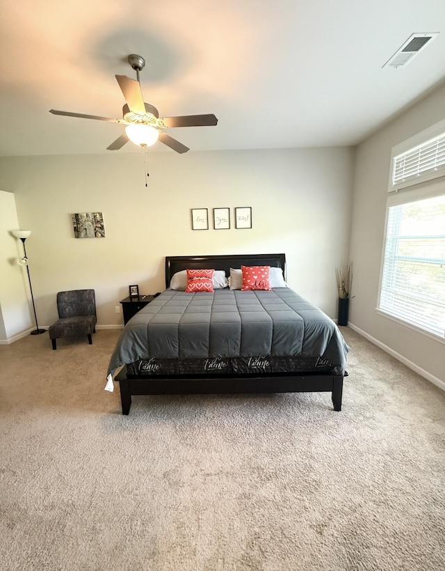 bedroom with baseboards, visible vents, carpet flooring, and ceiling fan