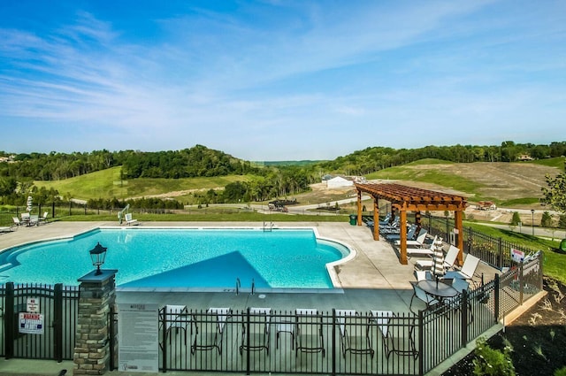pool featuring fence, a patio area, and a pergola