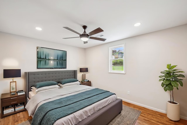 bedroom with wood finished floors, baseboards, recessed lighting, and ceiling fan