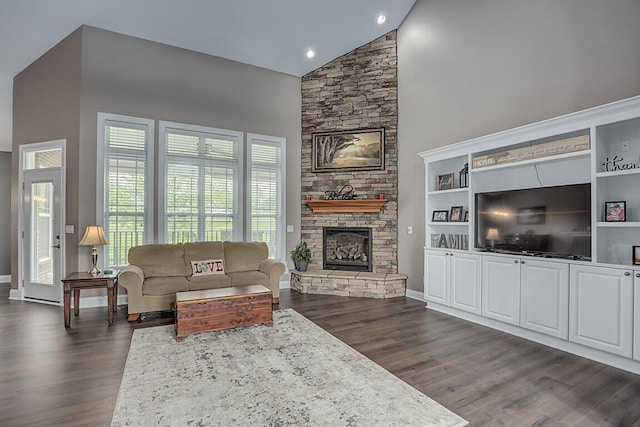 11660 Agarwood Dr, Walton, KY 41094 - living area with high vaulted ceiling, dark wood finished floors, a stone fireplace, and baseboards