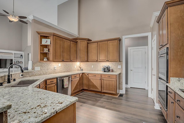 11660 Agarwood Dr, Walton, KY 41094 - kitchen with brown cabinetry, a ceiling fan, a sink, high vaulted ceiling, and stainless steel appliances