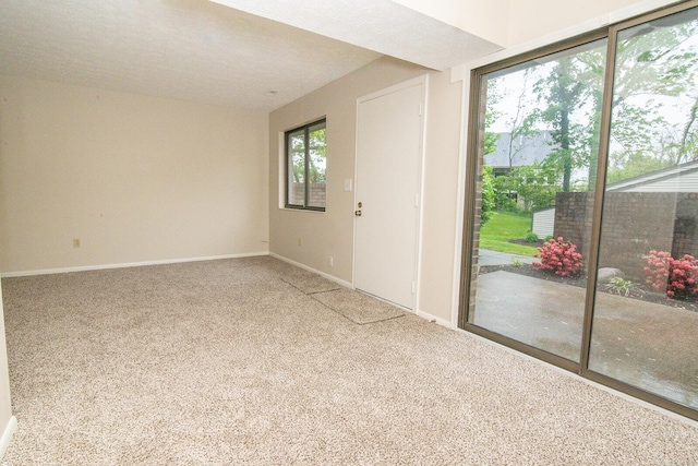 unfurnished room with baseboards and carpet