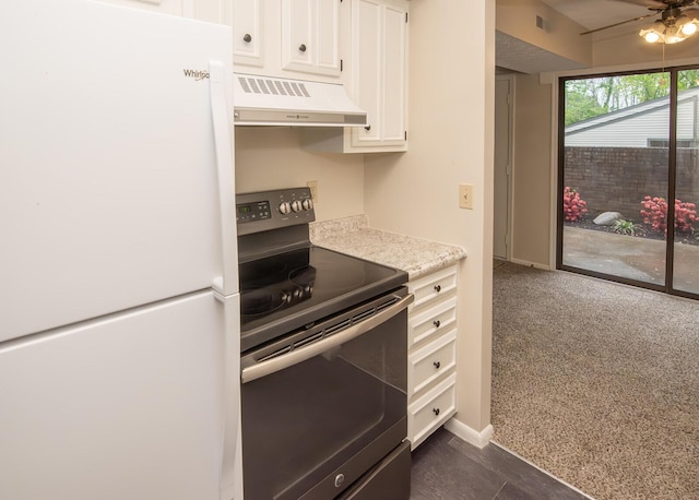 kitchen featuring visible vents, freestanding refrigerator, black electric range oven, ventilation hood, and white cabinetry