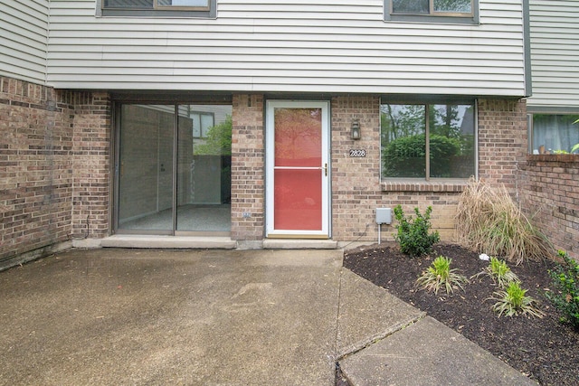 property entrance with brick siding