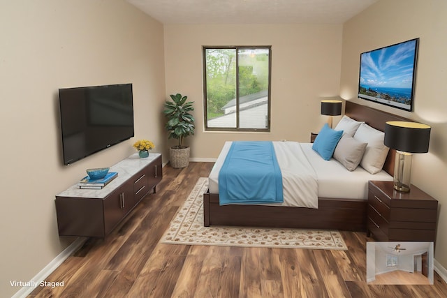 bedroom featuring baseboards and wood finished floors