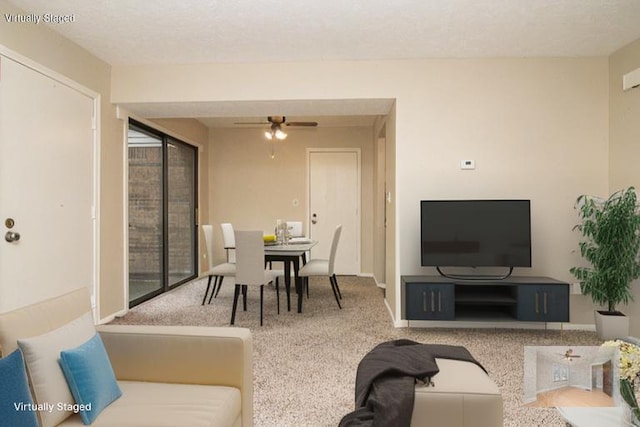 living room featuring carpet flooring and ceiling fan