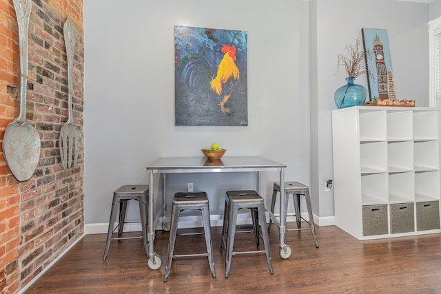 118 Electric Ave, Southgate, KY 41071 - dining area featuring brick wall, baseboards, and wood finished floors