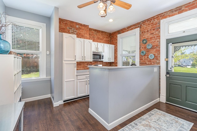 118 Electric Ave, Southgate, KY 41071 - kitchen featuring a ceiling fan, baseboards, stainless steel microwave, and white cabinetry