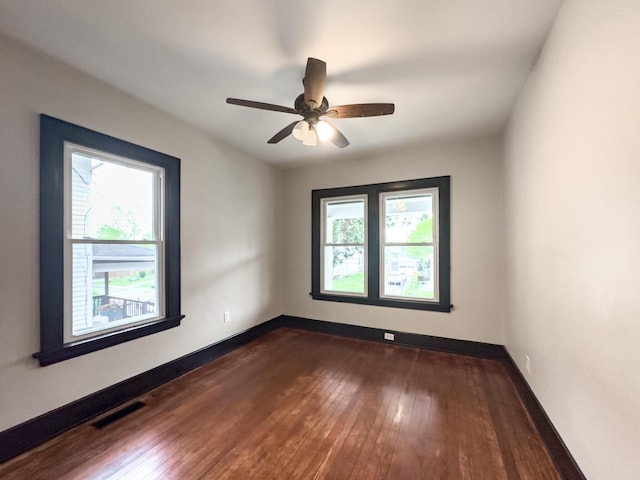 38 W 28th St, Covington, KY 41015 - empty room with baseboards, visible vents, and dark wood-style flooring