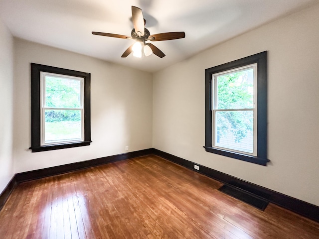 38 W 28th St, Covington, KY 41015 - unfurnished room with visible vents, baseboards, and dark wood-type flooring