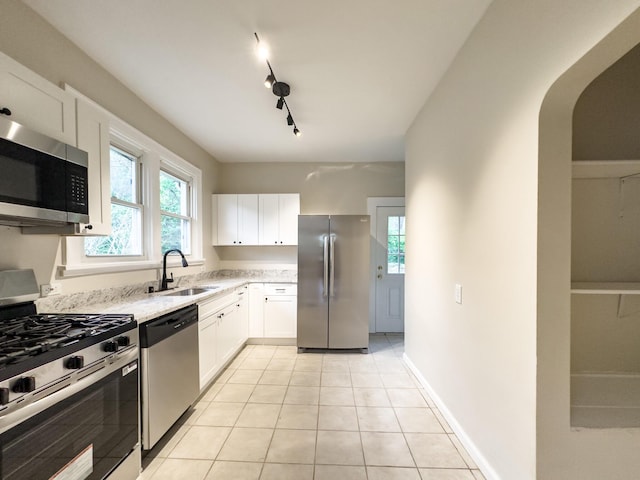 38 W 28th St, Covington, KY 41015 - kitchen with stainless steel appliances, a sink, white cabinetry, and light tile patterned flooring