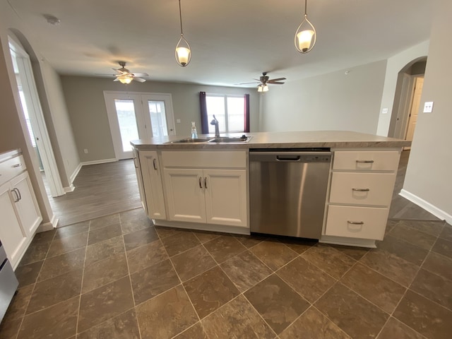 kitchen with arched walkways, dishwasher, a sink, and a ceiling fan
