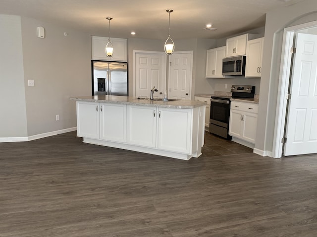 kitchen featuring white cabinets, appliances with stainless steel finishes, and a sink