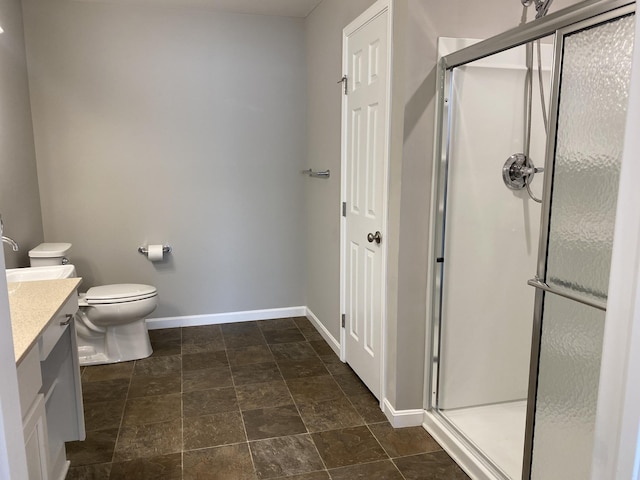 bathroom with a shower stall, baseboards, toilet, and vanity