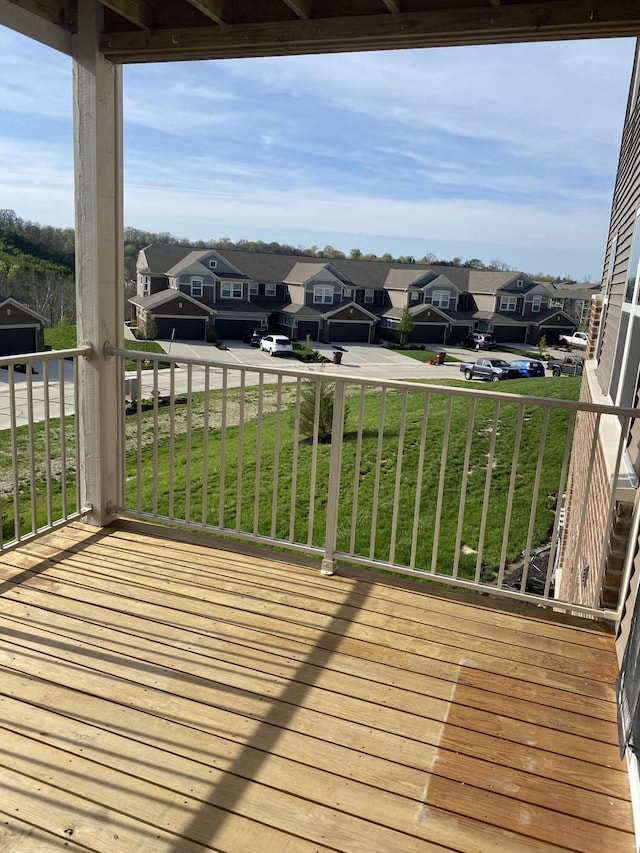 wooden deck featuring a yard and a residential view
