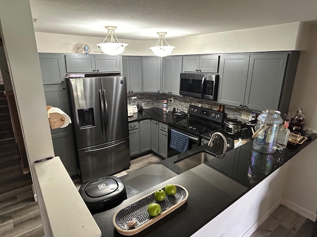 799 Slate Vw, Cold Spring, KY 41076 - kitchen featuring appliances with stainless steel finishes, gray cabinets, wood finished floors, dark countertops, and a sink