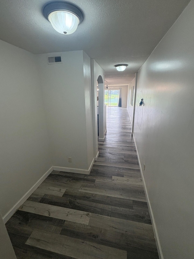 799 Slate Vw, Cold Spring, KY 41076 - hall featuring dark wood-style floors, arched walkways, baseboards, and a textured ceiling
