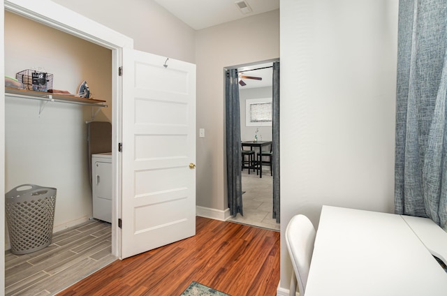 705 Bakewell St, Covington, KY 41011 - bedroom with baseboards, visible vents, wood finished floors, and washer / dryer