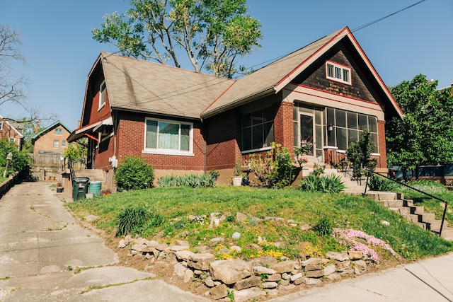 2225 Oakland Ave, Covington, KY 41015 - view of front of property featuring brick siding, driveway, and a shingled roof