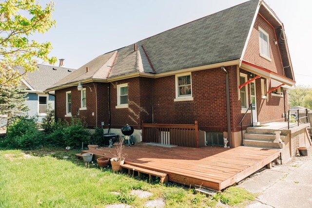 2225 Oakland Ave, Covington, KY 41015 - rear view of house with brick siding, roof with shingles, a lawn, and a deck