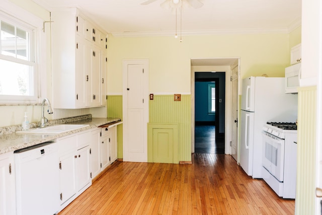2225 Oakland Ave, Covington, KY 41015 - kitchen featuring a sink, white appliances, a wainscoted wall, light wood finished floors, and white cabinets