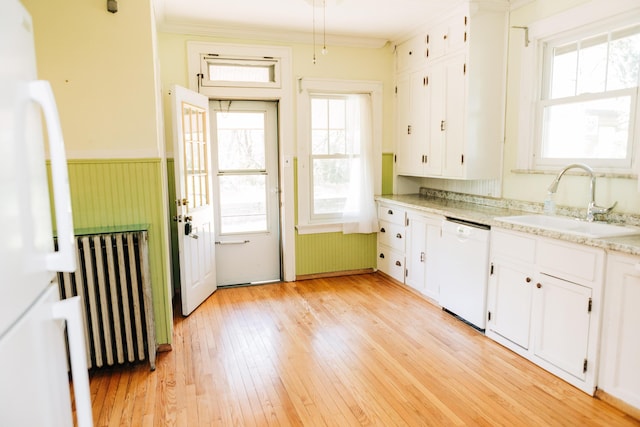 2225 Oakland Ave, Covington, KY 41015 - kitchen featuring radiator heating unit, plenty of natural light, white appliances, and a sink