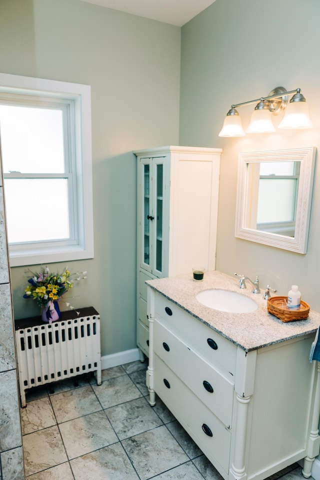 2225 Oakland Ave, Covington, KY 41015 - bathroom featuring radiator heating unit, baseboards, and vanity
