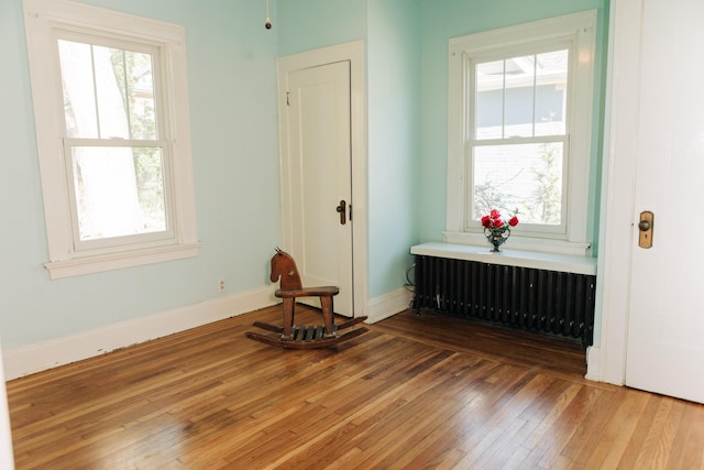 2225 Oakland Ave, Covington, KY 41015 - interior space with radiator, wood-type flooring, a wealth of natural light, and baseboards