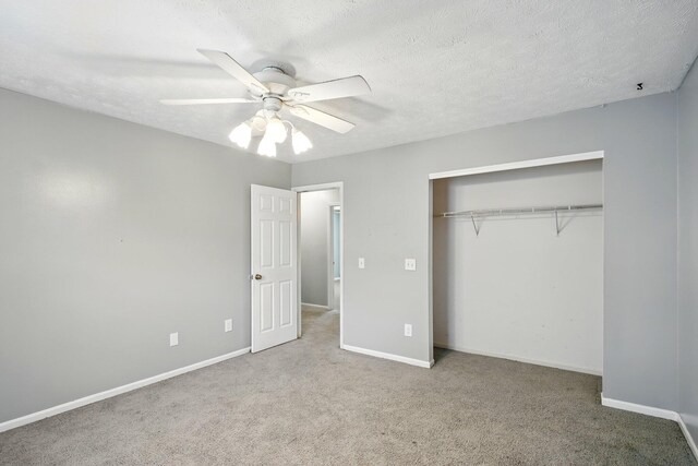 unfurnished bedroom with carpet flooring, a closet, and baseboards