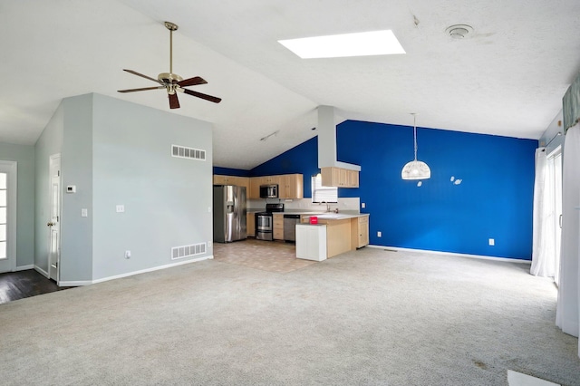 unfurnished living room featuring light carpet, a sink, baseboards, ceiling fan, and high vaulted ceiling