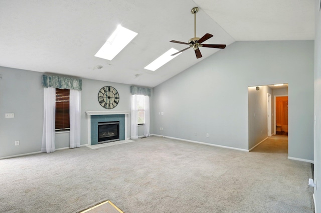 unfurnished living room featuring high vaulted ceiling, a fireplace with flush hearth, carpet floors, a ceiling fan, and baseboards